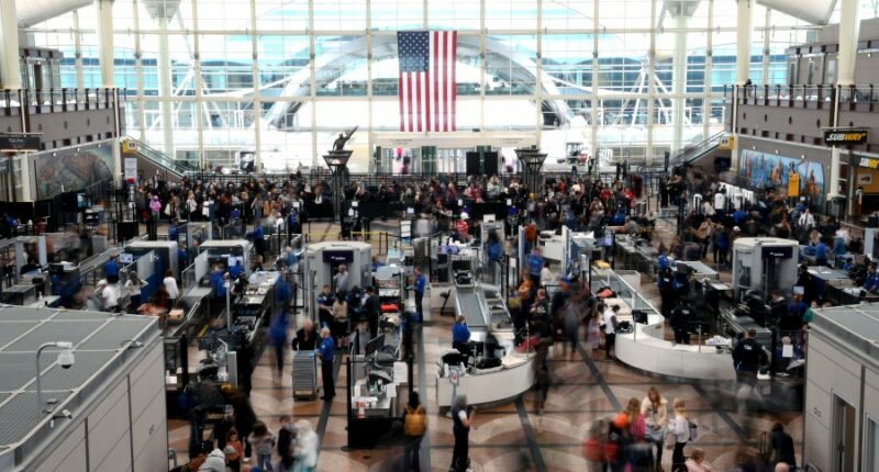 Passengers flee smoking jet on emergency slide after apparent landing gear problem at Denver airport