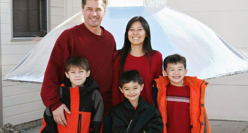 The Heene family smiles together in coordinating red outfits.