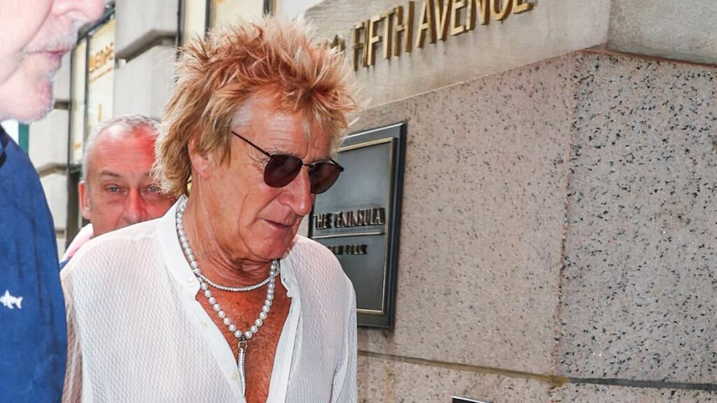 Rod Stewart, 80, cuts a dapper figure in pearl necklace and open-necked shirt as the stylish star steps out in New York City