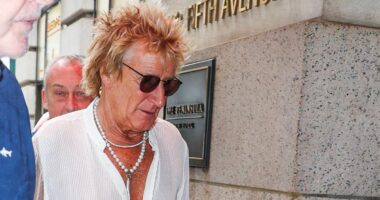 Rod Stewart, 80, cuts a dapper figure in pearl necklace and open-necked shirt as the stylish star steps out in New York City