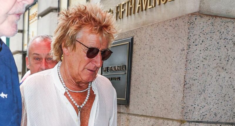 Rod Stewart, 80, cuts a dapper figure in pearl necklace and open-necked shirt as the stylish star steps out in New York City