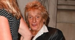 Rod Stewart, 80, wears a quirky satin blazer as he joins his leggy wife Penny Lancaster, 54, in New York City