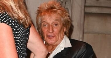 Rod Stewart, 80, wears a quirky satin blazer as he joins his leggy wife Penny Lancaster, 54, in New York City