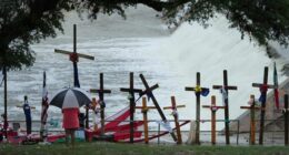 Rain falls over a make-shift memorial for flood victims along the Guadalupe River, Sunday, July 13, 2025, in Kerrville, Texas.