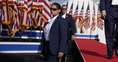 Secret Service agent suspended over Trump assassination attempt is unmasked... as widow of firefighter killed blasts agency