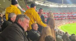 See the moment security has to step in and save Channel Seven star as he gets caught up in a heated clash with a rival fan at the footy