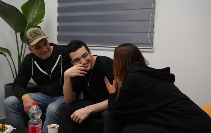 Edan Alexander smiles with family members