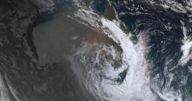 The thick cloud coverage is visible from space, with a clear crescent storm system floating above the East Coast.