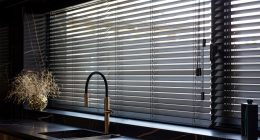 Black wooden blinds in a modern kitchen.