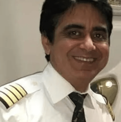 Portrait of a smiling pilot in uniform.