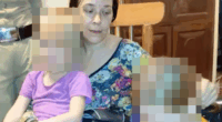 Woman holding two children.