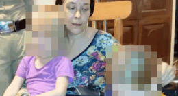 Woman holding two children.