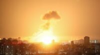 Ballistic missile explosion over a city at night.