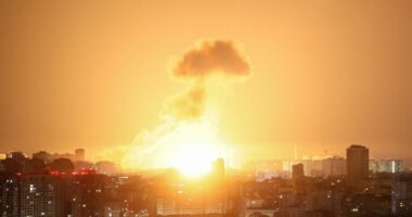 Ballistic missile explosion over a city at night.