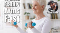Gym At Home. Positive Aged Woman Training With Dumbbells In Living Room, Copy Space. 4 Simple Arm-Toning Moves That Tighten Flabby Arms in 30 Days After 45. Cover