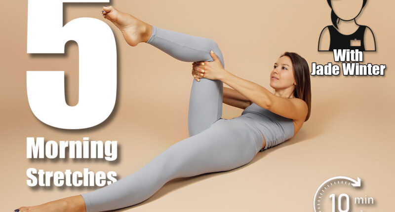 Brunette is engaged in fitness. Beautiful young woman in gray tight-fitting yoga suit does exercise on neutral beige background, she lies on her back and raises her knee to her chest, side view. 5 Bedroom Stretches That Boost Energy More Than Coffee After 50. Cover