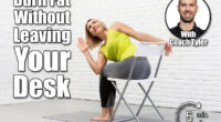Yoga with a chair. Adult caucasian woman sits and practice side twists with props on a mat in loft white studio indoor, selective focus.5 Desk Stretches That Burn More Fat Than a 30-Minute Walk After 40. Cover