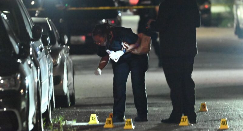 Forensic investigators collecting evidence at a mass shooting scene.