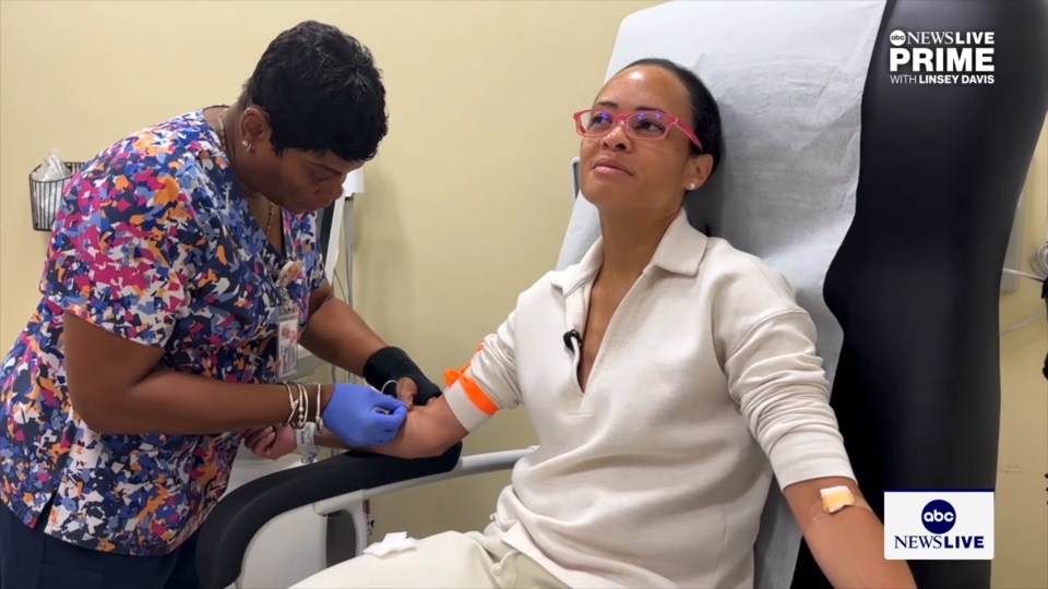 Screenshot of a nurse drawing blood from a patient.