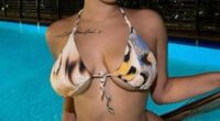 Photo of Lina Bina, also known as MissJohnDough, by a pool at night.