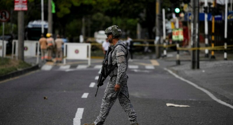Soldier patrolling a street after a bombing.