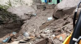 Building damaged by flash floods in a mountainous village.