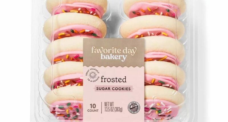 Ten frosted sugar cookies in a plastic container.