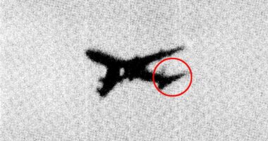 Grainy image of an aircraft with a circled detail.