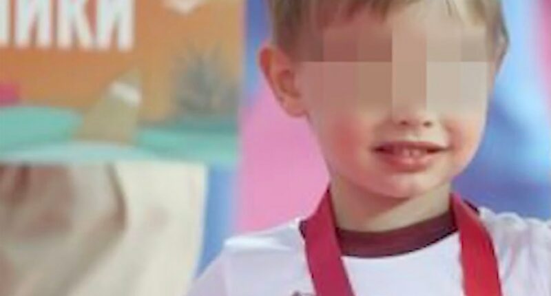 Photo of Vladimir Putin's youngest son with his face blurred.