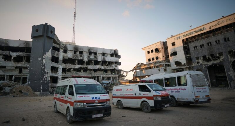 Ambulances parked outside damaged hospital buildings.