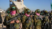 Hamas fighters stand in formation ahead of a hostages' release in Khan Younis, Gaza Strip, Saturday, Feb. 15, 2025. (AP Photo/Abdel Kareem Hana)