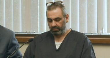 Man in dark shirt at court hearing.