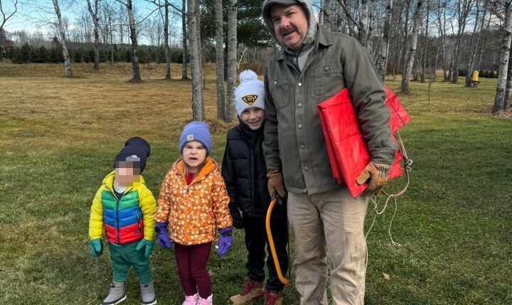 Family photo of a father and his three children.
