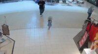 Security camera footage of a young girl walking alone in a mall.