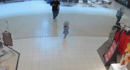 Security camera footage of a young girl walking alone in a mall.