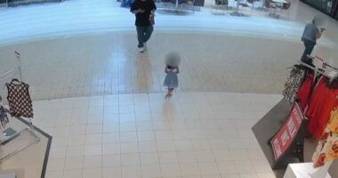 Security camera footage of a young girl walking alone in a mall.