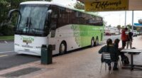InterCity Gold bus parked outside Tiffany's Cafe & Restaurant.