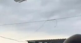 Pedal boat lifted by a tornado over a beach.
