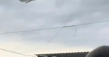 Pedal boat lifted by a tornado over a beach.