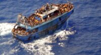 Overcrowded migrant boat at sea.