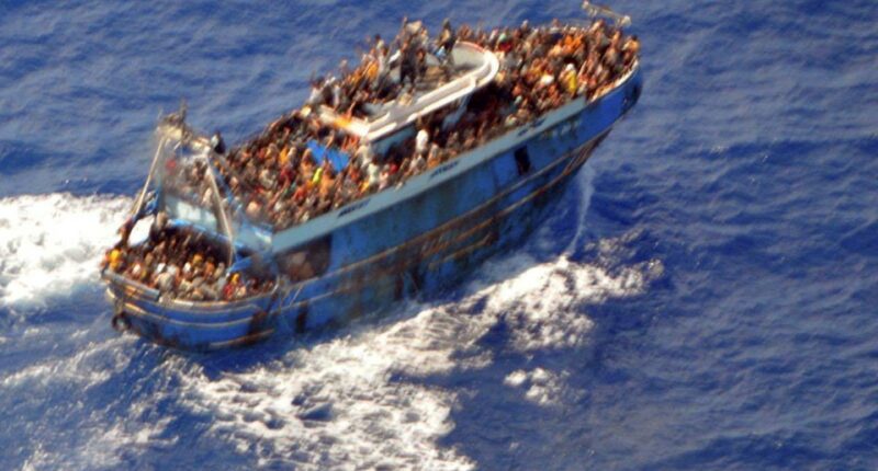 Overcrowded migrant boat at sea.
