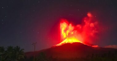 Mount Lewotobi Laki-laki volcano erupting at night.