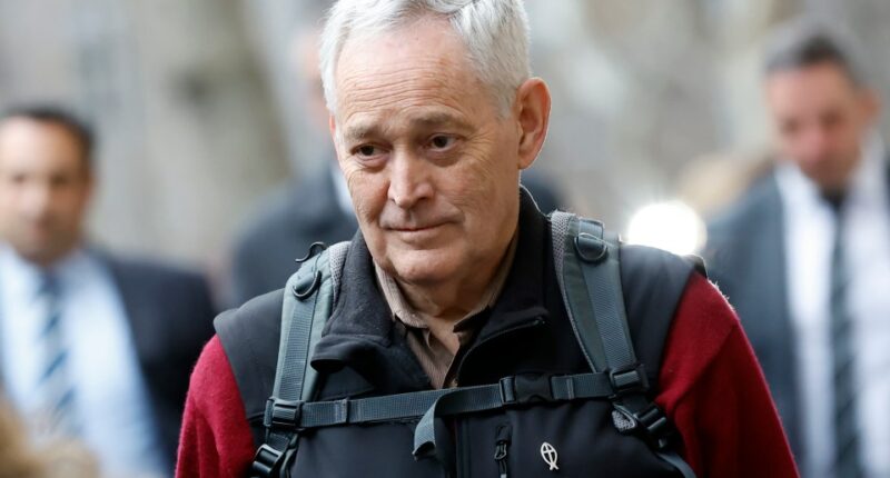 Close-up of a man with graying hair.