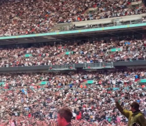 Thousands of Oasis fans at a sold-out Wembley Stadium concert.