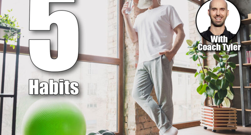 Full size photo of happy smiling mature man look window drinking water relaxing after difficult training at home house. If You Do These 5 Things Every Morning After 50, Fat Melts Off Faster Than Exercise. Cover