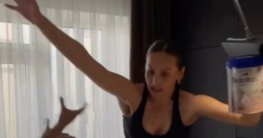 Woman attempting a high-heeled shoes challenge, falling.