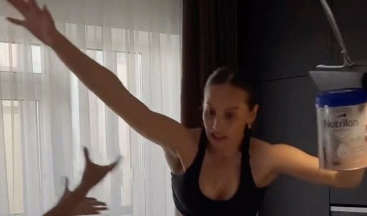 Woman attempting a high-heeled shoes challenge, falling.