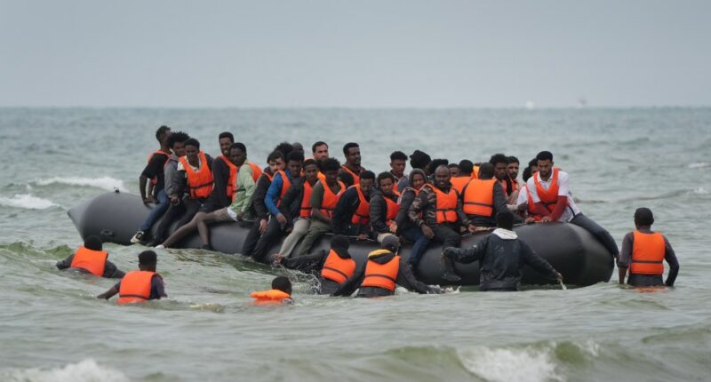 Migrants in a small boat at sea.