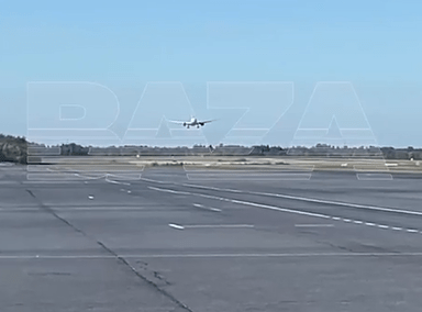 Airplane landing on a runway.