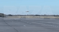 Airplane landing on a runway.